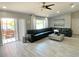 Bright living room with an open layout, stylish flooring, and access to the outdoor area at 1311 Fallwood Dr, Deltona, FL 32725