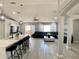 Open-concept living room with modern finishes, sleek flooring, and ample natural light at 1311 Fallwood Dr, Deltona, FL 32725