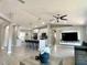 Open-concept kitchen and living area features modern cabinetry, bar seating, and an entertainment area at 1311 Fallwood Dr, Deltona, FL 32725