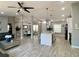 Open-concept living room with a ceiling fan and views to the dining room, kitchen, and front door at 1311 Fallwood Dr, Deltona, FL 32725