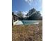 Backyard with a covered pool, some trees, and part of the house at 132 Wax Myrtle Ct, Sanford, FL 32773
