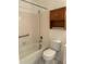 Clean bathroom featuring a tub and shower combination, toilet, and wood storage at 132 Wax Myrtle Ct, Sanford, FL 32773