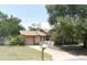 Charming single-story home with a driveway, lawn, and mature trees offering shade at 132 Wax Myrtle Ct, Sanford, FL 32773