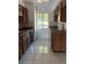 Kitchen with wood cabinets, tile floors, and an outside view at 132 Wax Myrtle Ct, Sanford, FL 32773