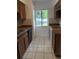 Functional kitchen featuring classic cabinetry, tile flooring, and a bright window at 132 Wax Myrtle Ct, Sanford, FL 32773