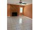 Living room featuring tile flooring, a wooden fireplace, a window, and a ceiling fan at 132 Wax Myrtle Ct, Sanford, FL 32773