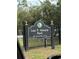 Lee P Moore Park sign at entrance with manicured landscaping at 132 Wax Myrtle Ct, Sanford, FL 32773