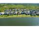 Back aerial view of waterfront property with lawn, and surrounding homes, showcasing the neighborhood at 133 Azure Mist Way, Daytona Beach, FL 32124