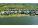 Aerial view showcasing homes along a serene lake, highlighting community living and waterfront properties at 133 Azure Mist Way, Daytona Beach, FL 32124