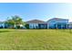 Spacious backyard featuring a well-maintained lawn and screened-in porch, perfect for outdoor enjoyment at 133 Azure Mist Way, Daytona Beach, FL 32124