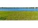 Lush green backyard leads to a tranquil lake, perfect for relaxation and enjoying nature's beauty at 133 Azure Mist Way, Daytona Beach, FL 32124