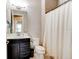 Bathroom featuring a dark vanity with a framed mirror, a toilet, and a bathtub with shower at 133 Azure Mist Way, Daytona Beach, FL 32124