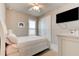 Comfortable bedroom featuring neutral walls, a ceiling fan, and a mounted TV for relaxed viewing at 133 Azure Mist Way, Daytona Beach, FL 32124
