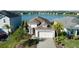 Stunning single Gathering home with lake view, manicured lawn, and paver driveway at 133 Azure Mist Way, Daytona Beach, FL 32124