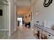 Bright hallway with tile flooring leading to an open-concept living area, showcasing seamless transitions and spacious design at 133 Azure Mist Way, Daytona Beach, FL 32124