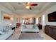 Spacious living room with stylish furnishings, a ceiling fan, and an open layout leading to the kitchen and dining area at 133 Azure Mist Way, Daytona Beach, FL 32124