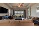 Bright living room with comfortable seating, a ceiling fan, and access to a screened patio overlooking the water at 133 Azure Mist Way, Daytona Beach, FL 32124