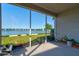 Screened-in patio offering stunning views of the lake, with green grass at 133 Azure Mist Way, Daytona Beach, FL 32124