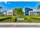 Beautifully landscaped residents club featuring a modern architectural design with stunning windows and inviting entrance at 133 Azure Mist Way, Daytona Beach, FL 32124