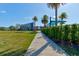 Scenic pathway to the residents club, surrounded by well-maintained landscaping and lush greenery at 133 Azure Mist Way, Daytona Beach, FL 32124