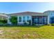 A close-up look at the back of the home, highlighting the screened in porch at 133 Azure Mist Way, Daytona Beach, FL 32124
