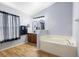 The bathroom features a garden tub and window with decorative curtains for privacy at 133 Brasswood Ct, Daytona Beach, FL 32117