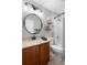 Clean bathroom features a granite countertop, decorative mirror, and tiled shower at 133 Brasswood Ct, Daytona Beach, FL 32117