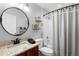 Well-lit bathroom with granite countertop, decorative mirror, and tiled shower at 133 Brasswood Ct, Daytona Beach, FL 32117