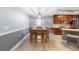Bright dining room with a wooden table set and hardwood floors, adjacent to the kitchen at 133 Brasswood Ct, Daytona Beach, FL 32117