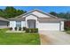 Charming single-story home with a well-manicured lawn and an attached two-car garage at 133 Brasswood Ct, Daytona Beach, FL 32117
