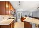 Well-equipped kitchen with granite countertops and stainless steel appliances, seamlessly flowing into the living space at 133 Brasswood Ct, Daytona Beach, FL 32117