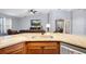 Open kitchen with granite countertops, stainless steel appliances, and view to the living room at 133 Brasswood Ct, Daytona Beach, FL 32117