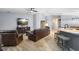 Comfortable living room with leather furniture, ceiling fan, and views into the kitchen at 133 Brasswood Ct, Daytona Beach, FL 32117