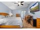 This primary bedroom features a ceiling fan, a work space, and wood flooring throughout at 133 Brasswood Ct, Daytona Beach, FL 32117