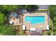 Aerial view of the community pool with ample lounge chairs and surrounding green space at 133 Brasswood Ct, Daytona Beach, FL 32117