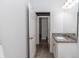 Bright bathroom with a white vanity, granite countertops, and a doorway at 1388 15Th St, Orange City, FL 32763