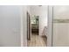 Bright bathroom featuring wood-look flooring, open doorway to bedroom, and step-in shower at 1388 15Th St, Orange City, FL 32763