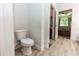 Bright bathroom with toilet and view to bedroom and closet at 1388 15Th St, Orange City, FL 32763
