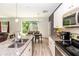 Bright kitchen featuring granite countertops, stainless steel appliances, and a view to the dining area at 1388 15Th St, Orange City, FL 32763