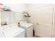 Bright laundry room features a washer, dryer, and shelving for optimal storage at 1388 15Th St, Orange City, FL 32763