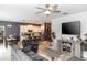 Open-concept living room and kitchen with modern decor, a ceiling fan, and bright natural light at 1388 15Th St, Orange City, FL 32763