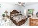 Comfortable main bedroom with a decorative bed frame, side tables with lamps, and a ceiling fan at 1388 15Th St, Orange City, FL 32763