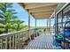 This covered outdoor balcony features white washed wood and provides views of scenic foliage at 14 Marsh Ct, Ponce Inlet, FL 32127
