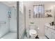Functional bathroom with glass block shower, white tiling, and well-lit vanity at 14 Marsh Ct, Ponce Inlet, FL 32127