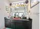 Bathroom vanity with eclectic decor, unique mirror, and a quirky, vintage sink basin at 14 Marsh Ct, Ponce Inlet, FL 32127
