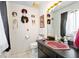 Bathroom featuring a vibrant pink sink, artistic mask decorations, and modern fixtures at 14 Marsh Ct, Ponce Inlet, FL 32127