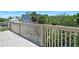 Relaxing deck with a view of neighborhood trees and a glimpse of the community pool at 14 Marsh Ct, Ponce Inlet, FL 32127