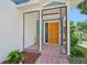 Enclosed entryway with an eye-catching yellow door, offering curb appeal and privacy at 14 Marsh Ct, Ponce Inlet, FL 32127