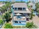 Aerial view of a two-story blue home, showcasing its expansive decks at 14 Marsh Ct, Ponce Inlet, FL 32127
