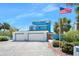 Charming blue home with a three-car garage and an American flag waving proudly at 14 Marsh Ct, Ponce Inlet, FL 32127